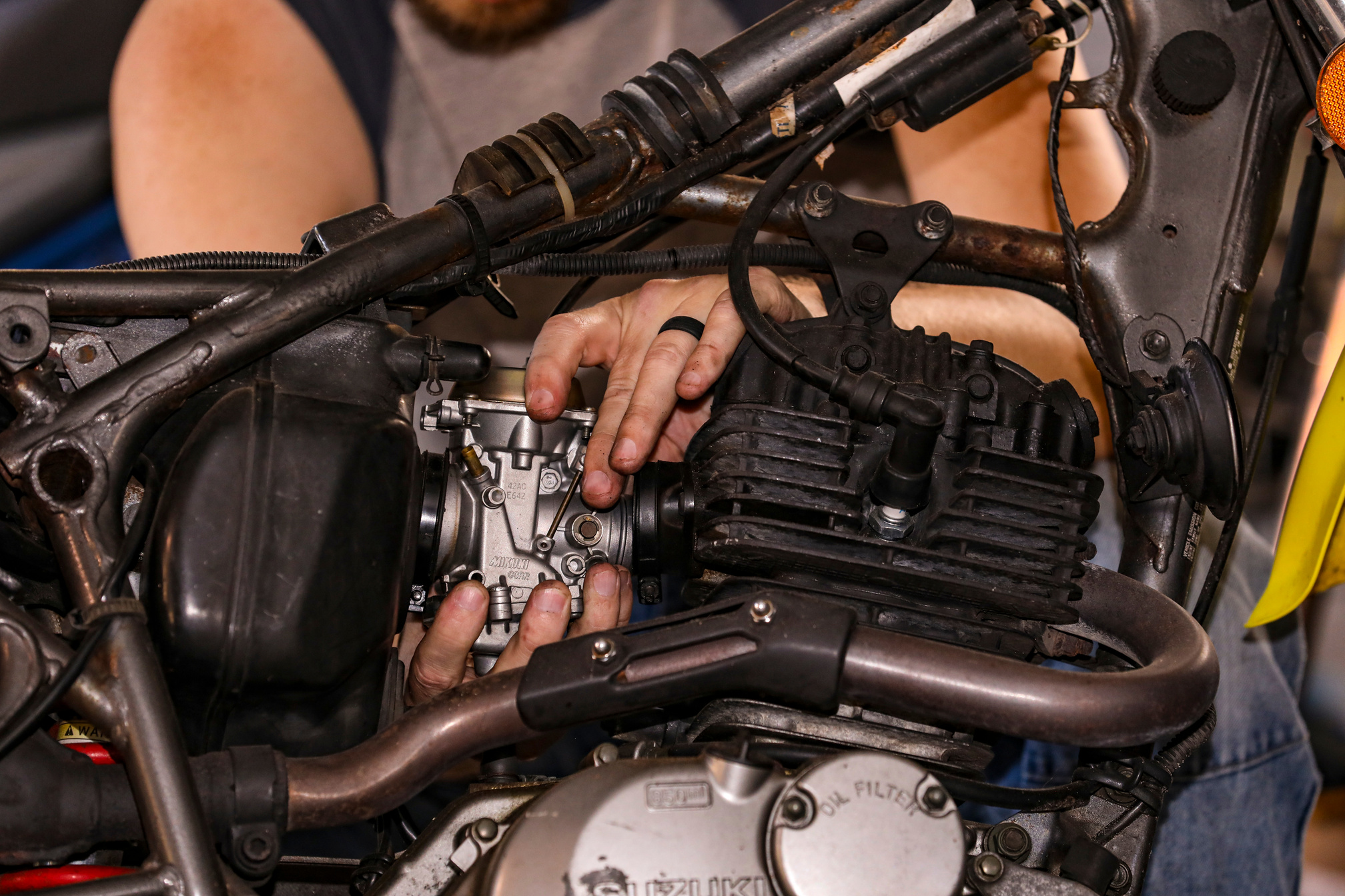 Close-Up Shot of a Person Fixing an Engine of a Motorcycle